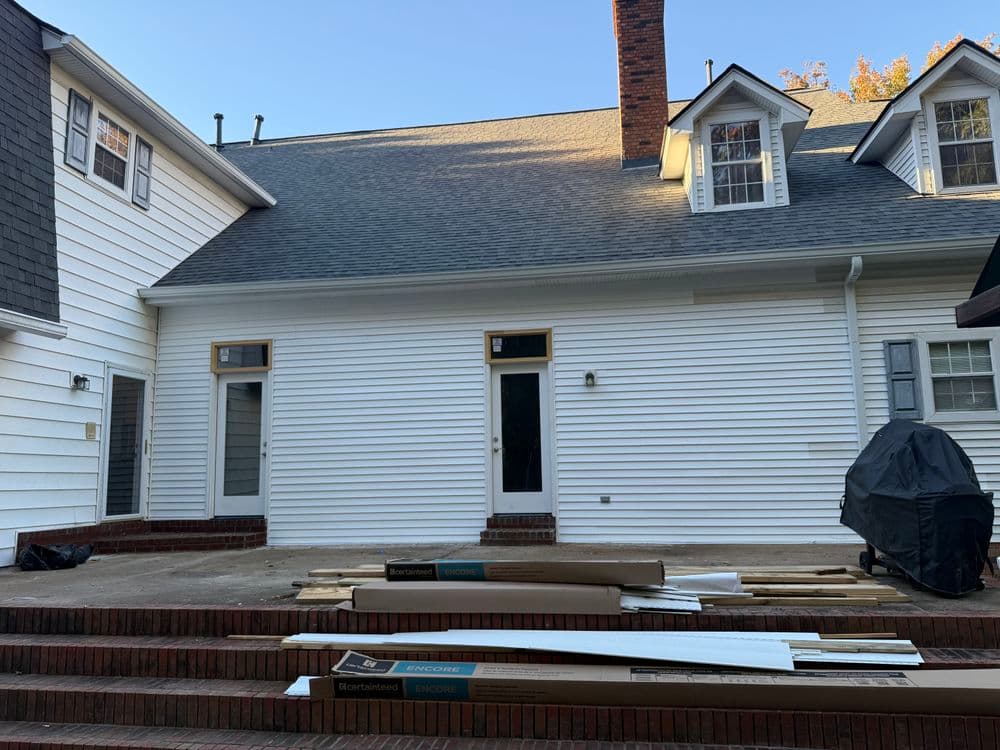 Residential exterior view of newly renovated home with construction materials in the foreground.