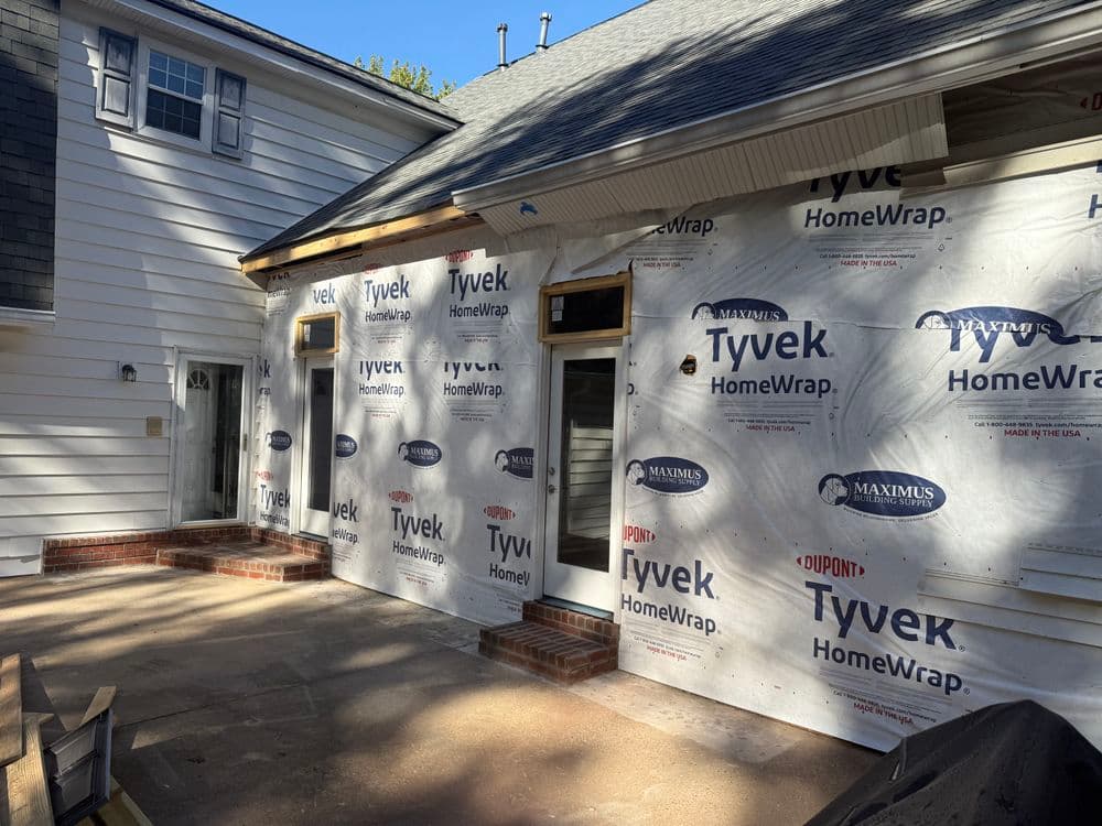 Home renovation featuring Tyvek HomeWrap on a residential building exterior.